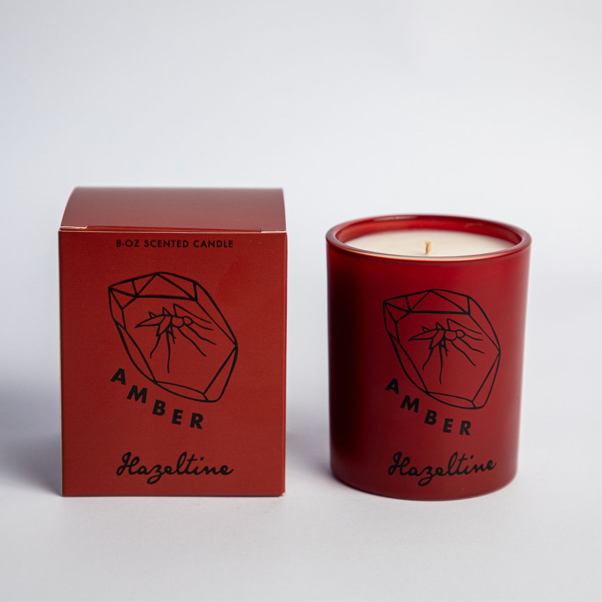 amber scented candle in brown jar with box